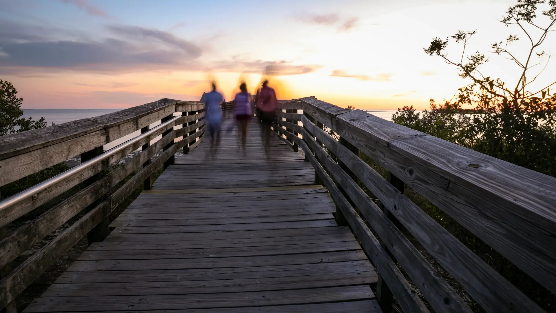 brown wooden bridge during sunset